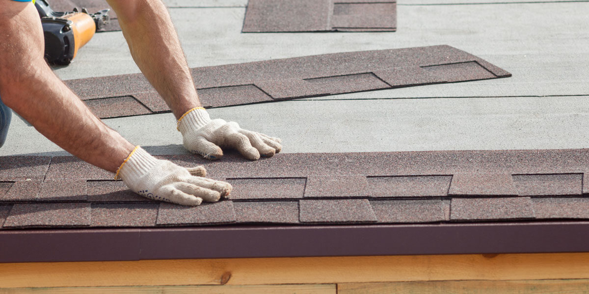 Close up of roofer replacing tiles on a roof