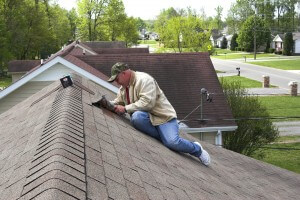 A person repairing roof of the building