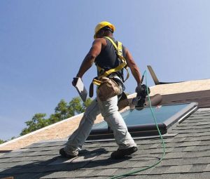 roofer walking across a roof in progress