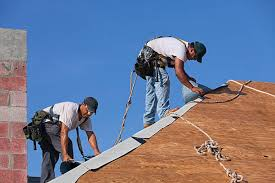 workers with harnes on the roof