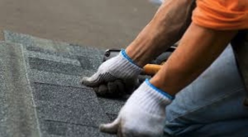 up close view of roofer lining up asphalt shingles